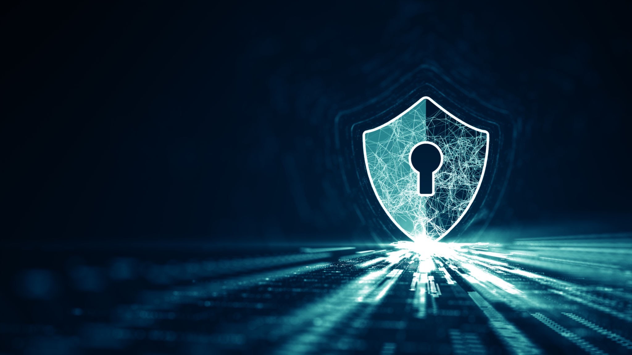 An abstract glowing digital shield over a cyber security neural network mesh to illustrate the concept of total security software protecting a PC from zero-day threats.