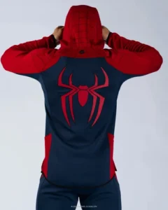 Back view of a person wearing a red and dark blue Spider-Man hooded jacket with a large red spider symbol printed across the back and web patterns on the hood.